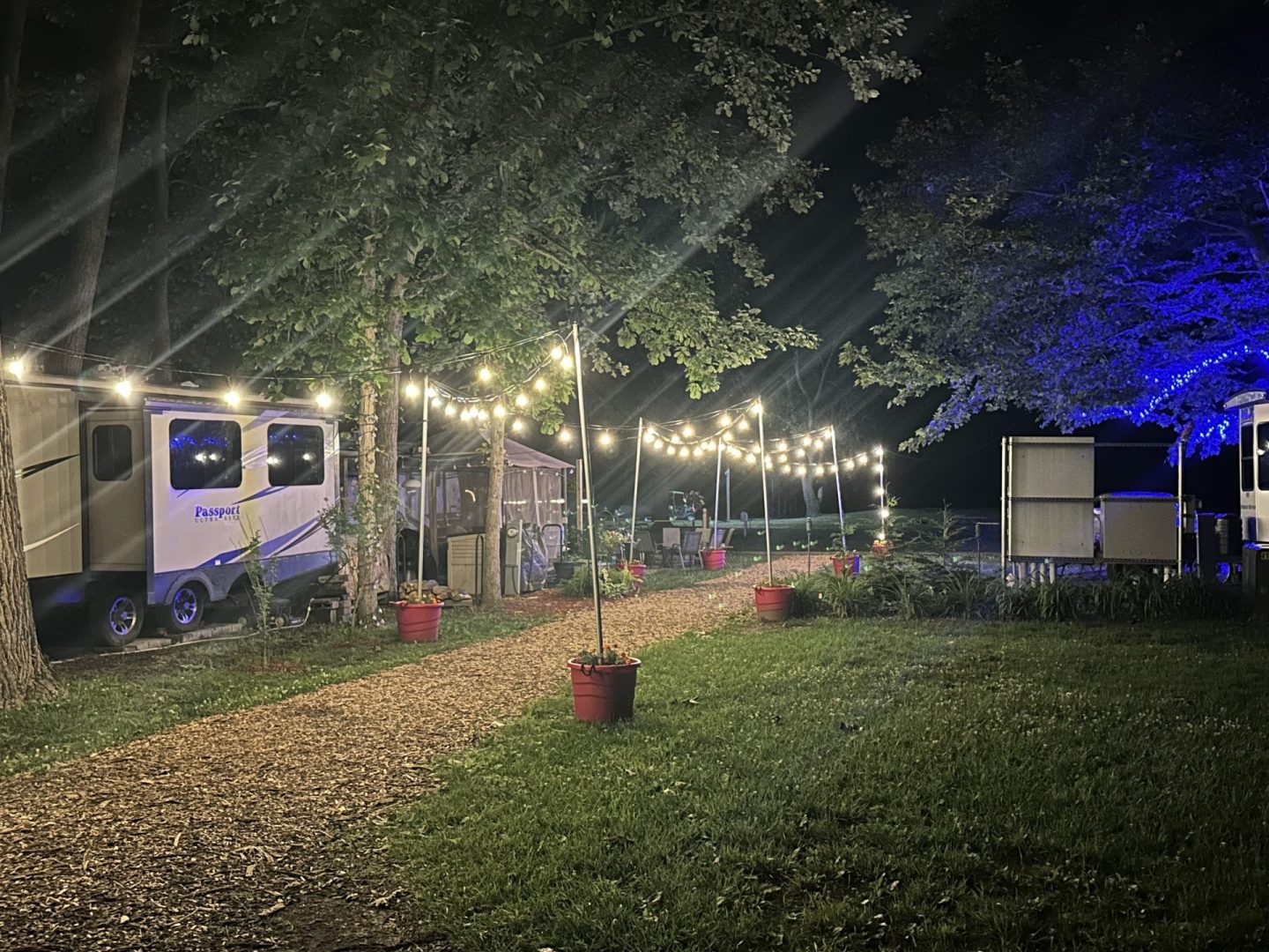 Decorated RV campsites with string lights during the evening at CreekRidge Campground.